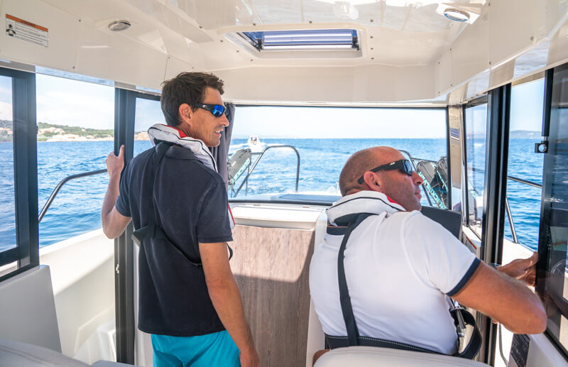 Quicksilver 705 Pilothouse, twee mannen bij stuurstand op zee