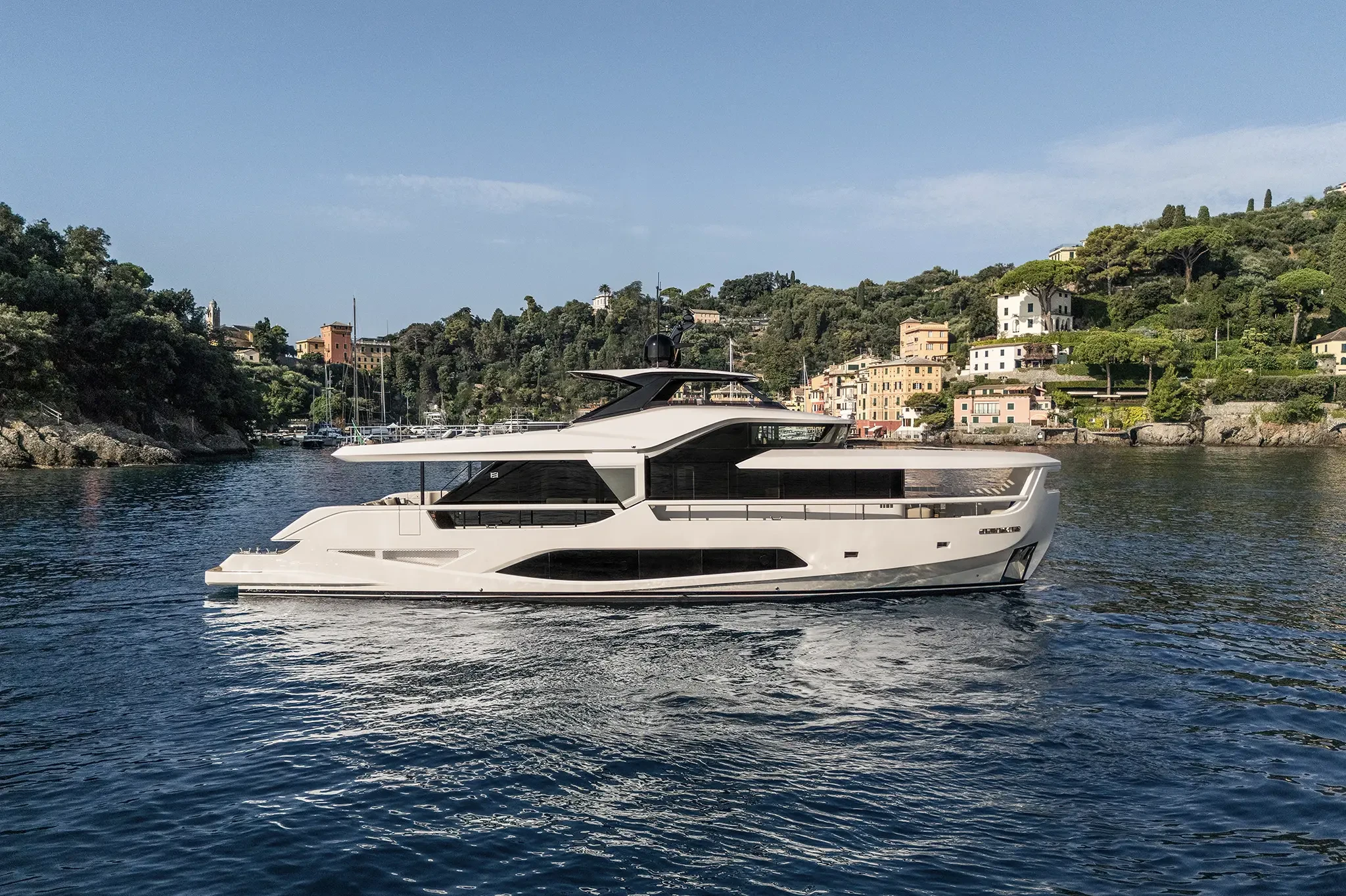Ferretti Infynito 80, luxe jacht varend nabij kustdorp