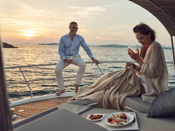 Prestige 520, koppel ontspant op jacht bij zonsondergang