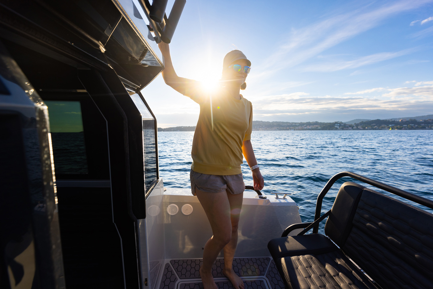 XO DFNDR 8, vrouw staat op achterdek boot